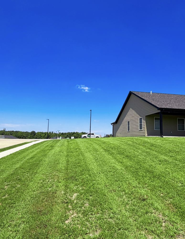 Freshly mowed new-construction lawn beside a home